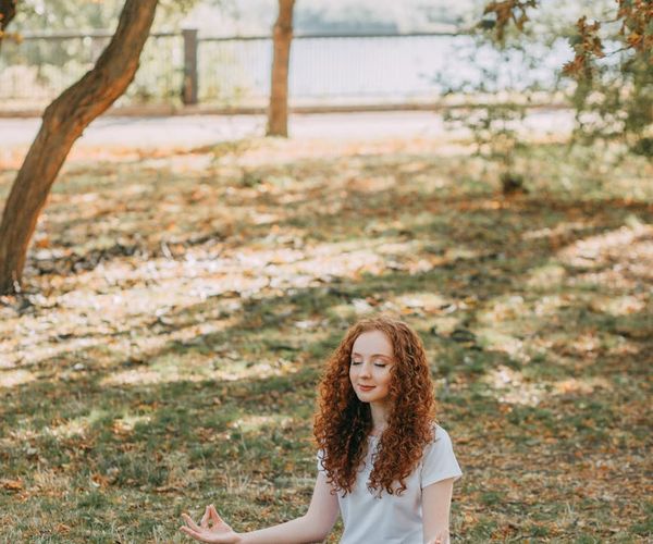 Person stretching in a calm, natural environment, feeling peaceful.